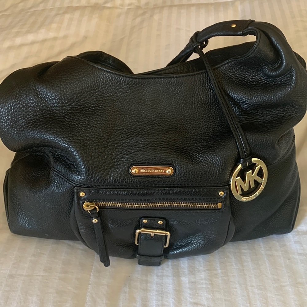 MICHAEL KORS- Black very soft leather shoulder bag. Gold touch, snap closure.